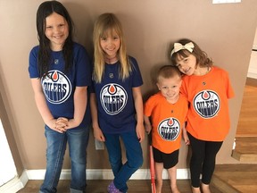 The Hove children wearing their signed Edmonton Oilers shirts (from left): MaryLynn, 8; Vienna, 7; Jonah, 3; and Hannah, 5.