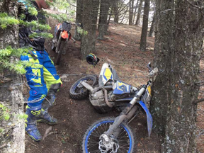 A dirt bike lays on the ground after a close encounter with barbed wire in Porcupine Hills. | Facebook photo