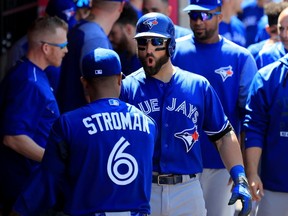 Kevin Pillar is congratulated by Marcus Stroman of the Toronto Blue Jays in the dugout after hitting a home run during the eighth inning of a game against the Los Angeles Angels of Anaheim at Angel Stadium of Anaheim on April 23, 2017. (Sean M. Haffey/Getty Images)