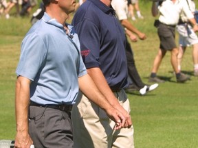 Wayne Gretzky, right, and Mike Weir walk the Northern Bear golf course during the Gretzky and Friends golf tournament on July 23, 2002. (File)