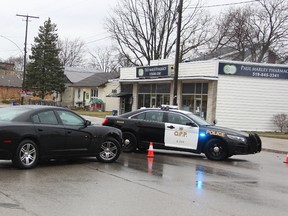 Lambton OPP vehicles are shown in this file photo blocking Broadway Street in Wyoming after a pharmacy robbery March 7, 2017. Earlier that day, there was an attempted robbery at a Sarnia pharmacy. A Sarnia man has been arrested in Calgary and is charged in connection with a series of pharmacy robberies in southwestern Ontario. File Photo/Sarnia Observer/Postmedia Network