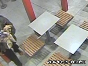A man holds a Yorkshire terrier on the patio of a McDonald's on Sandalwood Pkwy. in Brampton on April 15, 2017 in this image captured by security video.