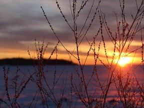 The sun rises over Lake Athabasca, seen from the shores of Fort Chipewyan, in this December 2014 file photo. Vincent McDermott/Fort McMurray Today/Postmedia Network