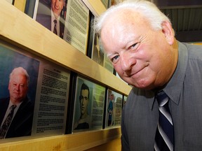 The late Jon Gibbons checks out his plaque when he was inducted into the Quinte West Sports Wall of Fame in 2013. He died Sunday at the age of 70. (Intelligencer file photo by Luke Hendry)