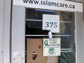 Damage to the front door of the Islam Care Centre at 375 Somerset St. near Bank was covered up with cardboard in mid-April. WAYNE CUDDINGTON / POSTMEDIA