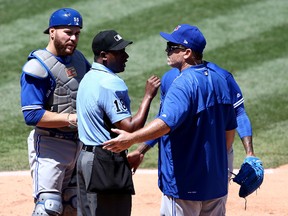 Homeplate umpire Ramon De Jesus talks with Blue Jays manager John Gibbons and catcher Russell Martin during a MLB game against the Los Angeles Angels of Anaheim on April 23, 2017. (Sean M. Haffey/Getty Images)