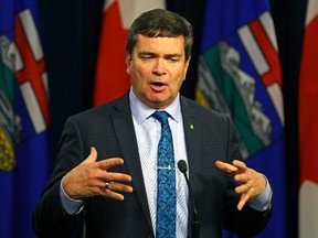 Oneil Carlier, Alberta Minister of Agriculture & Forestry, responds to the softwood lumber dispute with the United States, at the Alberta Legislature in Edmonton on April 25, 2017.