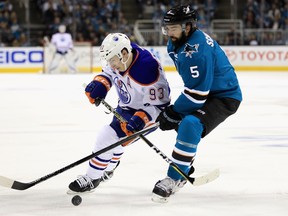 Ryan Nugent-Hopkins #93 of the Edmonton Oilers and David Schlemko #5 of the San Jose Sharks go for the puck during Game Six of the Western Conference First Round during the 2017 NHL Stanley Cup Playoffs at SAP Center on April 22, 2017 in San Jose, California.
