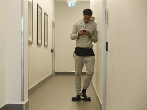 Toronto Raptors guard DeMar DeRozan in the hallway of the BioSteel basketball complex texting before speaking to the media as they prepare for Game 6 against the Milwaukee Bucks in Toronto on April 25, 2017. (Jack Boland/Toronto Sun/Postmedia Network)