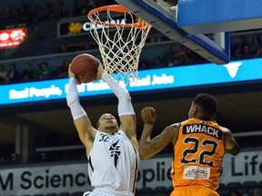 Lightning guard Joel Friesen flies to the basket past Island Storm defender Rashad Whack during the first half of their National Basketball League of Canada game at Budweiser Gardens on Tuesday night. The Lightning won 123-117. (MORRIS LAMONT, The London Free Press)