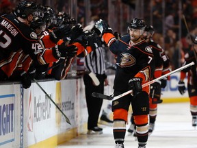 Anaheim Ducks left wing Andrew Cogliano high-fives his teammates after scoring a goal during the third period of an NHL hockey game against the New York Rangers, Sunday, March 26, 2017, in Anaheim, Calif.