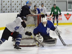 London Nationals starter Cameron Zanussi watches from behind the net as fellow goalie Trenton McGrail stops forward Kyle Dawson?s wraparound during practice at the Western Fair Sports Centre on Tuesday. The Nationals open the Sutherland Cup final against Elmira at Westn Fair tonight. (MORRIS LAMONT, The London Free Press)