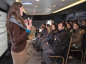 Education associate Daniella Lurion talks to grade 11 religion students at St. John's College on Thursday, February 26, 2015 aboard the Tour for Humanity Bus. The mobile classroom, presented by the Friends of Simon Wiesenthal Centre for Holocaust Studies enabled students to watch a presentation on the Holocaust, universal genocide and real-world heroes. Brian Thompson/Brantford Expositor/QMI Agency