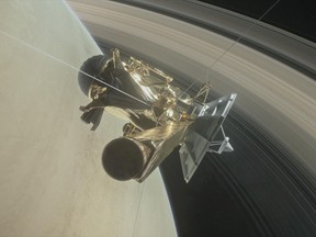 This NASA handout illustration obtained April 6, 2017 shows NASA's Cassini spacecraft about to make one of its dives between Saturn and its innermost rings as part of the mission's grand finale. (AFP PHOTO/NASA/JPL-CALTECH/Handout)