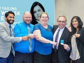 Cashco CEO, Tim Latimer, shows off a new Cashco Everyday Use Account debit card that can be used at ATB banking machines.