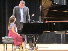 Adjudicator Alde Calongcagong, from Windsor, speaks to Lin Qi Core, 10, of Sarnia following her performance Wednesday April 26, 2017 at the Sarnia Library Theatre, during the Lambton County Music Festival. The festival, now in its 88th year, continues next week at venues around Sarnia.
 Paul Morden/Sarnia Observer/Postmedia Network