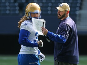 Quarterbacks coach Buck Pierce (right) speaks with FB John Rush during the Winnipeg Blue Bombers spring camp at Investors Group Field in Winnipeg on Wed., April 26, 2017. Kevin King/Winnipeg Sun/Postmedia Network