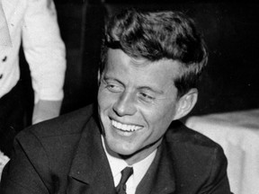 In this Feb. 9, 1944, file photo, U.S. Navy Lt. John F. Kennedy smiles at the Stork Club in New York. A diary written by Kennedy in 1945 during his brief stint as a journalist after World War II is being auctioned on April 26, 2017, by RR Auction in Boston. (AP Photo/File)