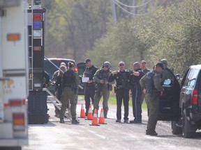 Police descended on Walker Road in Oneida Nation, Ont. in search of a man with a hand gun suspected of assault and taking a hostage on Wednesday. (Mike Hensen/The London Free Press)