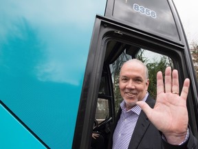 B.C. NDP leader John Horgan waves from his campaign bus following a media availability in Burnaby, B.C., Tuesday, April 25, 2017. (THE CANADIAN PRESS/Jonathan Hayward)