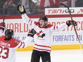 Travis Sanheim, left, and Mitch Marner of Canada celebrate a goal during a IIHF World Junior Ice Hockey Championship game against Finland on Jan. 2, 2016. (Markku Ulander/Lehtikuva via AP)