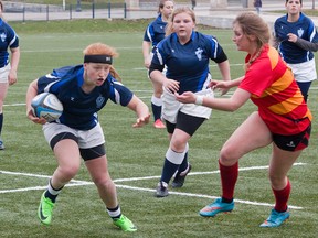 Zoe Spronk of the Kingston Blues races up Nixon Field on opening day of the Kingston Area Secondary Schools Athletic Association girls rugby season last Thursday. The Blues downed the Sydenham Golden Eagles, 15-12. Eight teams are involved in girls rugby, compared to five in senior boys. (Tim Gordanier/The Whig-Standard)