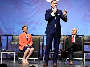 Conservative leadership candidate Maxime Bernier speaks as Andrew Scheer, Kellie Leitch and Rick Peterson listen during the Conservative Party of Canada leadership debate in Toronto on Wednesday April 26, 2017. THE CANADIAN PRESS/Nathan Denette