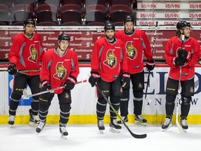 Cody Ceci, Jean-Gabriel Pageau, Clarke MacArthur, Mark Stone, Mike Hoffman and Dion Phaneuf gather along the boards as the Ottawa Senators practise at the Canadian Tire Centre on April 26, 2017. (Wayne Cuddington/Postmedia)