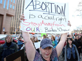 Leanne Parrish, along with hundreds of other pro-choice supporters, met at the Human Rights Monument in Ottawa to call upon the city to do more to protect those going to and working at the Morgentaler abortion clinic. JEAN LEVAC / POSTMEDIA NEWS