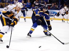 Nashville Predators' Cody McLeod (55) and St. Louis Blues' Joel Edmundson (6) chase after a loose puck during the third period in Game 1 of an NHL hockey second-round playoff series, Wednesday, April 26, 2017, in St. Louis. The Predators won 4-3. (AP Photo/Jeff Roberson)
