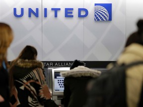 In this Wednesday, March 15, 2017, photo, people stand in line at a United Airlines counter at LaGuardia Airport in New York. (AP Photo/Seth Wenig)