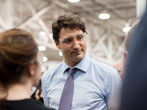 Prime Minister Justin Trudeau speaks with a few apprentices at the Frank Hasenfratz Centre of Excellence in Manufacturing in Guelph, Ont. on Tuesday, April 25, 2017. THE CANADIAN PRESS/Hannah Yoon
