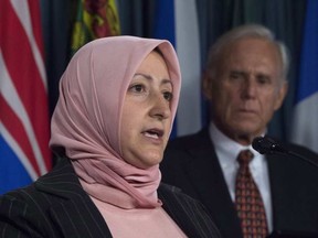 Raina Tfaily, wife of Hassan Diab, a Canadian held in France on terror charges, addresses a news conference Thursday as his Canadian lawyer Don Bayne looks on. ADRIAN WYLD / THE CANADIAN PRESS