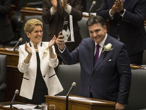 Premier Kathleen Wynne and Ontario Finance Minister Charles Sousa reading of the budget at Queen's Park on Thursday April 27, 2017. (Craig Robertson/Toronto Sun)