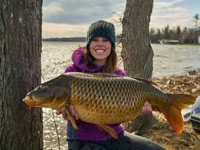 Columnist Ashley Rae with a personal-best carp, weighing 32 pounds, she caught on Lake Ontario. (Supplied photo)