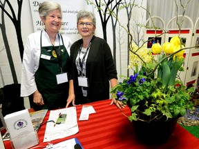 Sandy Wilson, president of the Garden Club of London, left, and club member Linda Hawker greet visitors at London?s Home and Outdoor Show last week. (MORRIS LAMONT, The London Free Press)