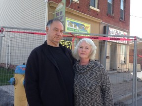 Stephen and Anne Hull stand in front of their property at 117 John St. in Napanee on Thursday. The deterioration of the adjacent property caused the building to be deemed unsafe in 2013 and after more than four years of fighting with the town an order has been given to demolish the building. (Elliot Ferguson/The Whig-Standard)
