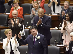 Ontario Finance Minister Charles Sousa delivers the 2017 Ontario budget next to Premier Kathleen Wynne at Queen's Park in Toronto on Thursday. NATHAN DENETTE / THE CANADIAN PRESS
