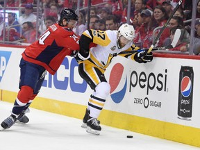 Washington Capitals defenseman John Carlson (74) vies for the puck against Pittsburgh Penguins right wing Bryan Rust (17) during the first period of Game 1 in an NHL hockey Stanley Cup second-round playoff series, Thursday, April 27, 2017, in Washington. (AP Photo/Nick Wass)