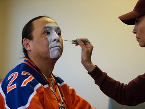 Edmonton Oilers superfan Blair Gladue has his face painted Oilers' colors by his sister Cora Gladue, in Edmonton Thursday April 27, 2017.