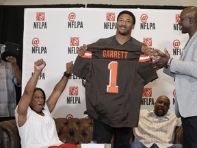 First-overall pick Myles Garrett holds up a Cleveland Browns jersey last night. (AP PHOTO)