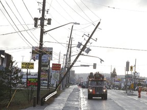 Greater Sudbury Utilities crews were on the scene at Lasalle Boulevard where a hydro pole was hanging precariously over the road in Sudbury, Ont. on Thursday April 27, 2017. The road was closed while crews worked to fix the problem.Thursday afternoon's downburst levelled many trees and shingles in the Greater Sudbury area. Gino Donato/Sudbury Star/Postmedia Network
