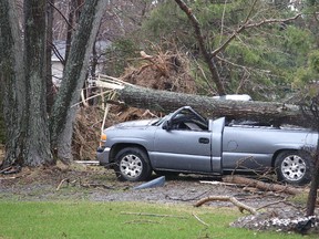 A fallen tree crushed a pickup truck at a home on Falconbridge Road in Sudbury, Ont. on Thursday April 27, 2017. Thursday afternoon's downburst levelled many trees and shingles in the Greater Sudbury area. Gino Donato/Sudbury Star/Postmedia Network