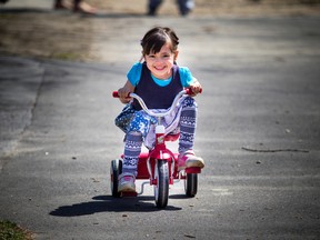 Four year old Serena Commisso was all smiles getting to ride her Radio Flyer trike through Saint Luke's Park off Elgin.
