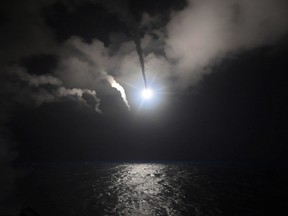 In this file image provided on April 7, 2017 by the U.S. Navy, the guided-missile destroyer USS Porter (DDG 78) launches a tomahawk land attack missile in the Mediterranean Sea. (Mass Communication Specialist 3rd Class Ford Williams/U.S. Navy via AP/File)