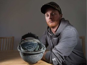 Ethan Allard died during a construction incident in January 2017. His brother, Tyson, pictured above, poses with a hard hat with Ethan's name etched on it. WAYNE CUDDINGTON / POSTMEDIA