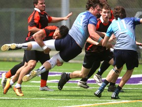 Tazie Vang Bell of Clarke Road tackles Michael Asma of Lucas near the Clarke Road try line during their rugby game on Western's Alumni field on Friday April 28, 2017. The first half was tight with Clarke Road converting a try for a 7-5 lead over Lucas, but after some changes at the half, Lucas scored two unconverted tries to win 15-7. (MIKE HENSEN, The London Free Press)