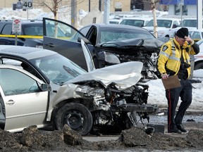 Police investigate a fatal collision on March 8, 2012. The name of Const. Chris Luimes, who was driving a police vehicle involved in the crash, was removed from police disciplinary records. An 84-year-old woman was killed in the crash.