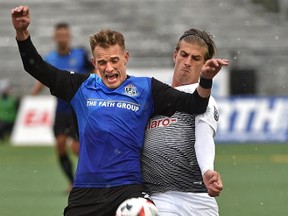 FC Edmonton Dean Shiels (22) and Puerto Rico FC Conor Doyle (8) battle for the ball during NASL action at Clarke Stadium in Edmonton, April 22, 2017.