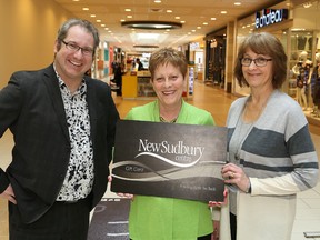 Tim Thomson, media sales consultant with The Sudbury Star, and Brenda Folz, right, marketing director of the New Sudbury Centre, presented Phyllis Skiffington with gift cards at the shopping centre in Sudbury, Ont. Skiffington is the grand prize winner in The Star's annual ice guessing contest. John Lappa/Sudbury Star/Postmedia Network